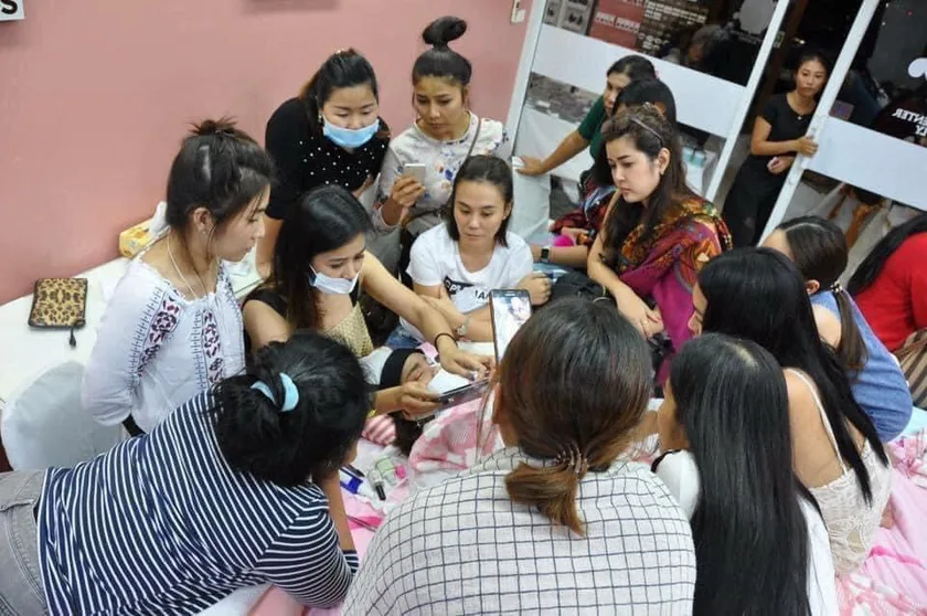 Students gathered around a model during a practical session