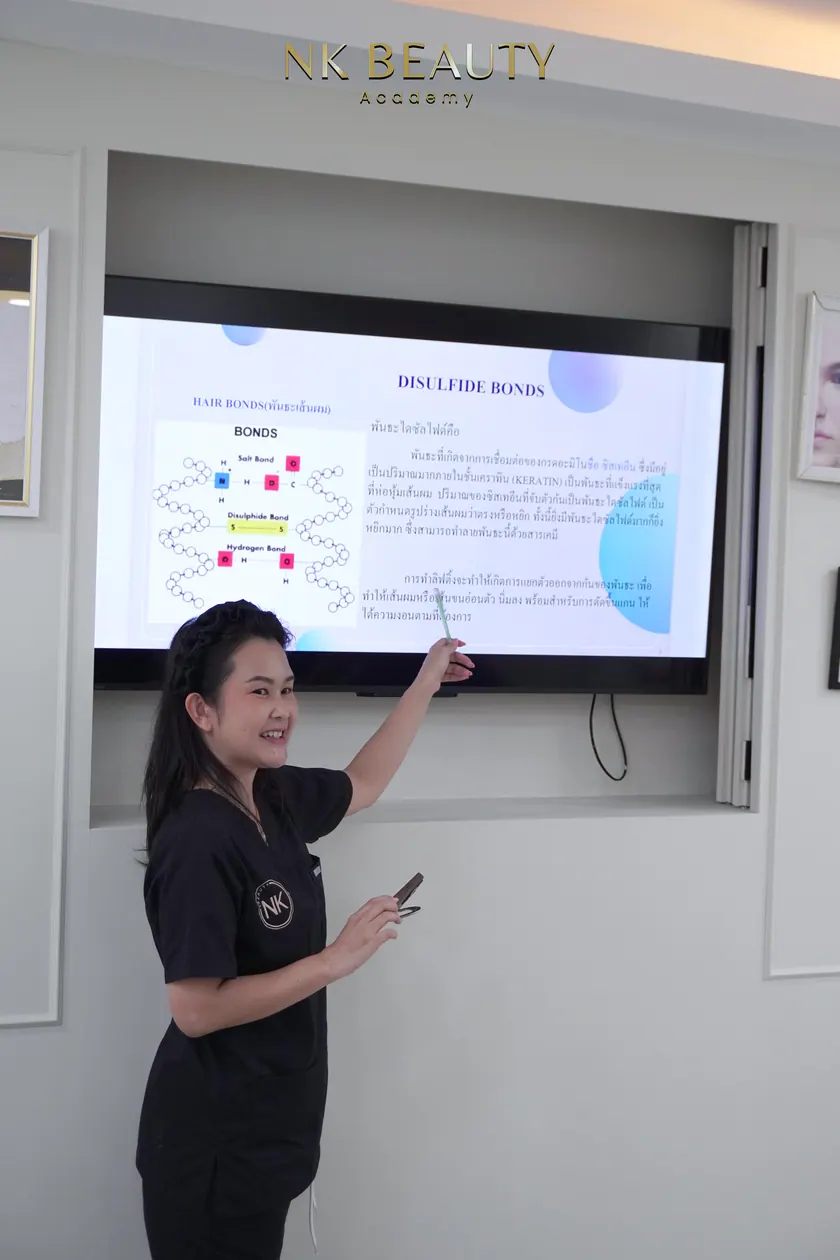 A theory session at NK Beauty Academy, the instructor working through the material with the group