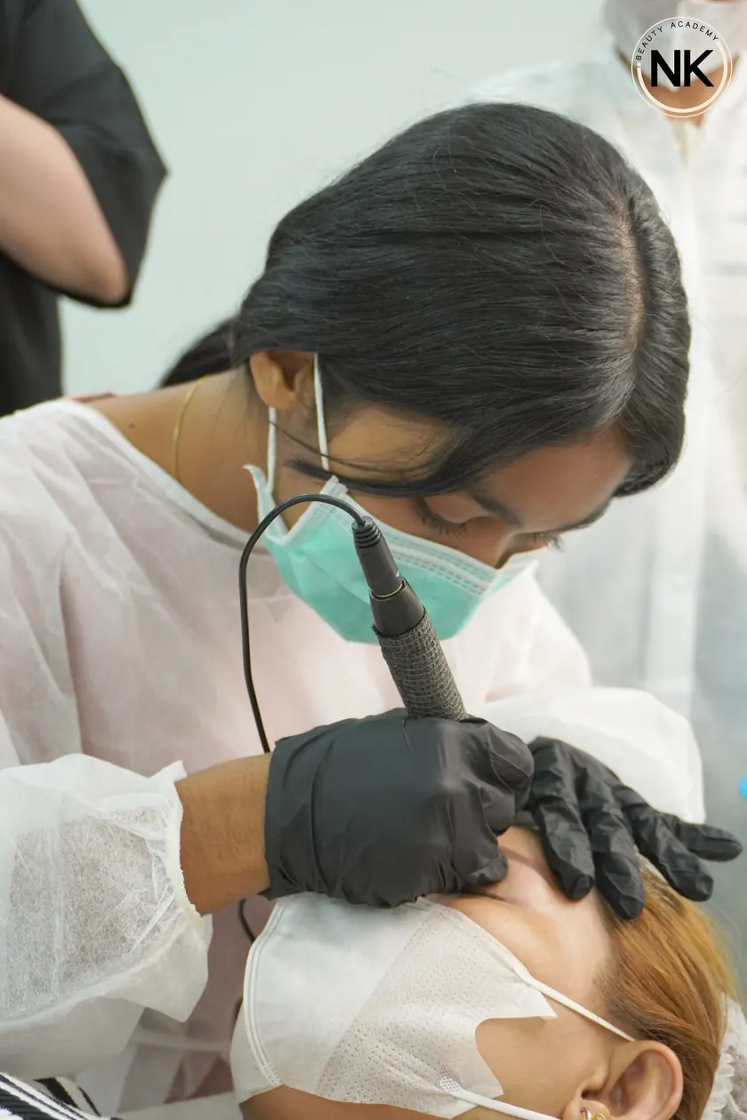 A student working on a live model during the hands-on part of the course