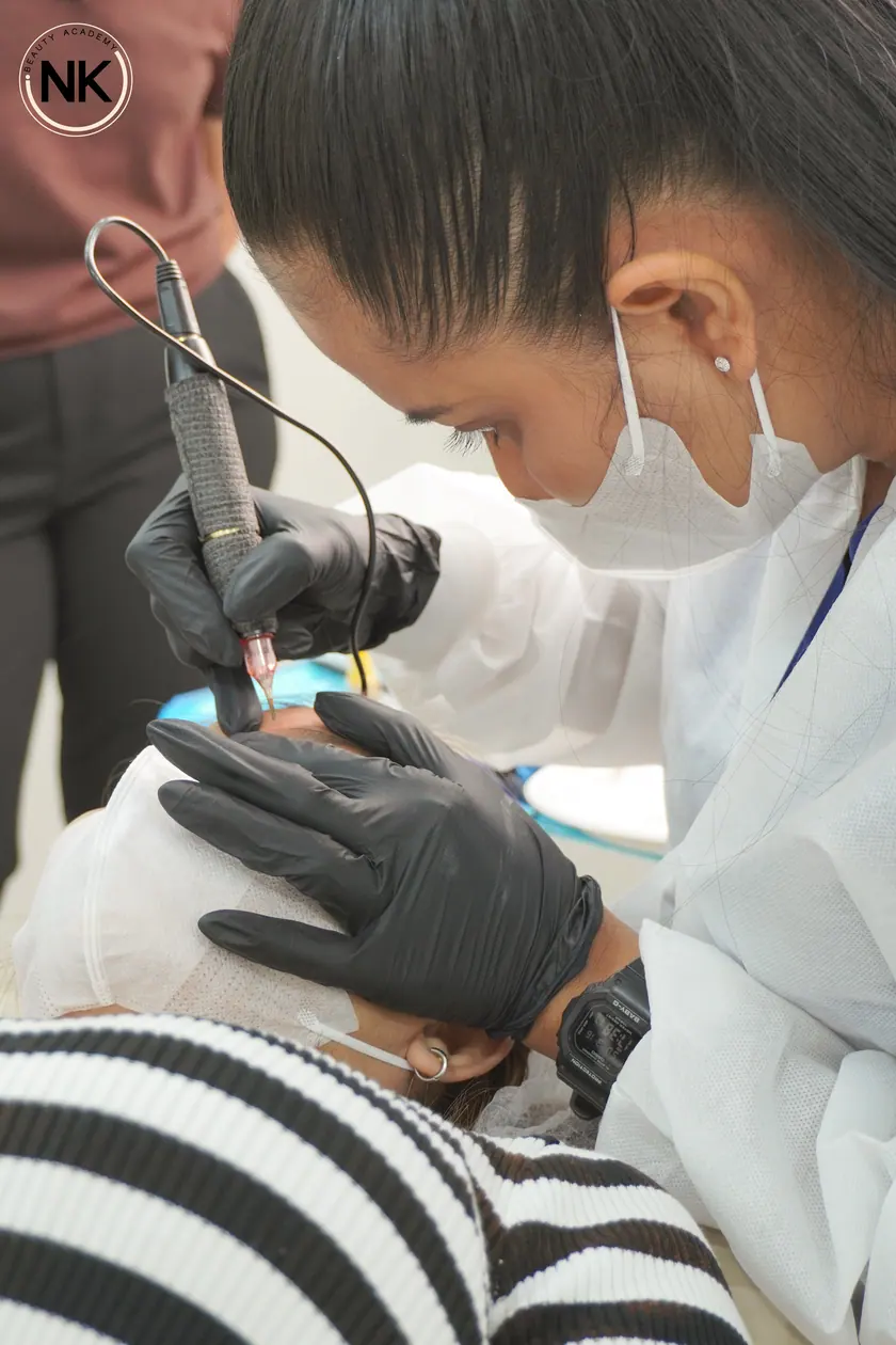 A student working on a live model during the hands-on part of the course