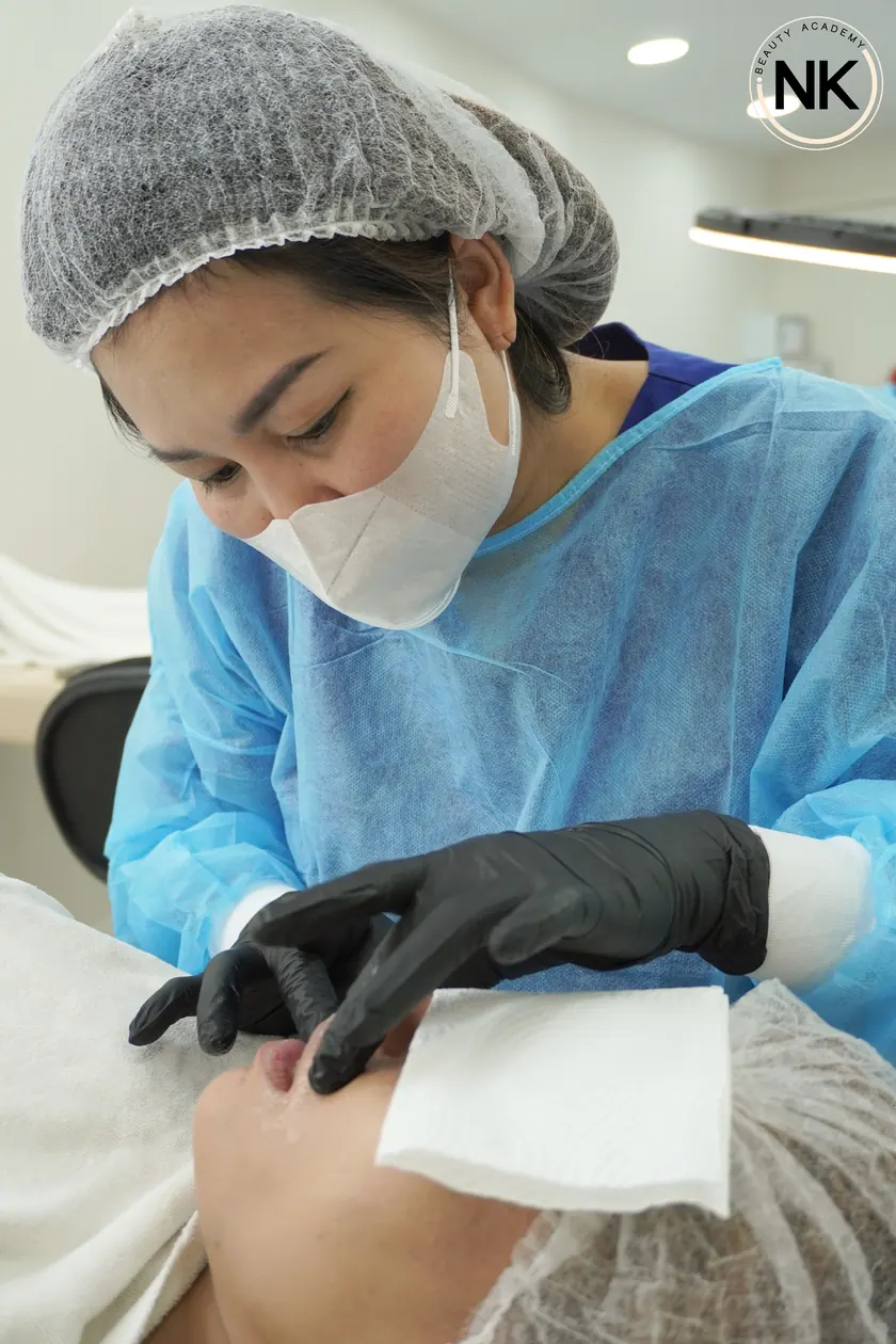 A student working on a live model during the hands-on part of the course
