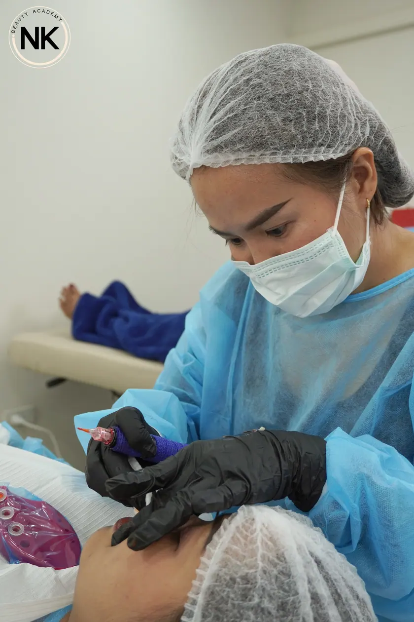 A student working on a live model during the hands-on part of the course