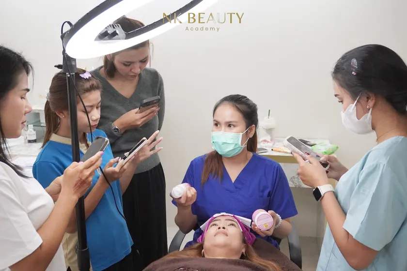 The group gathered around a live model while a technique is demonstrated