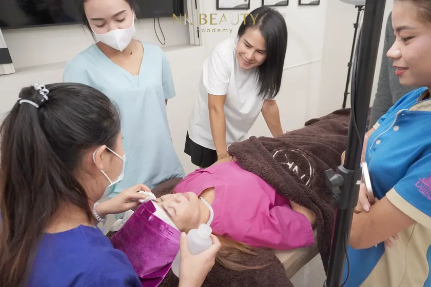 A student working on a live model during the hands-on part of the course