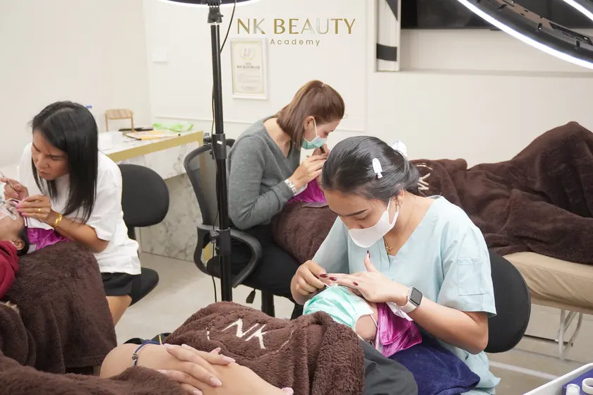 The group gathered around a live model while a technique is demonstrated