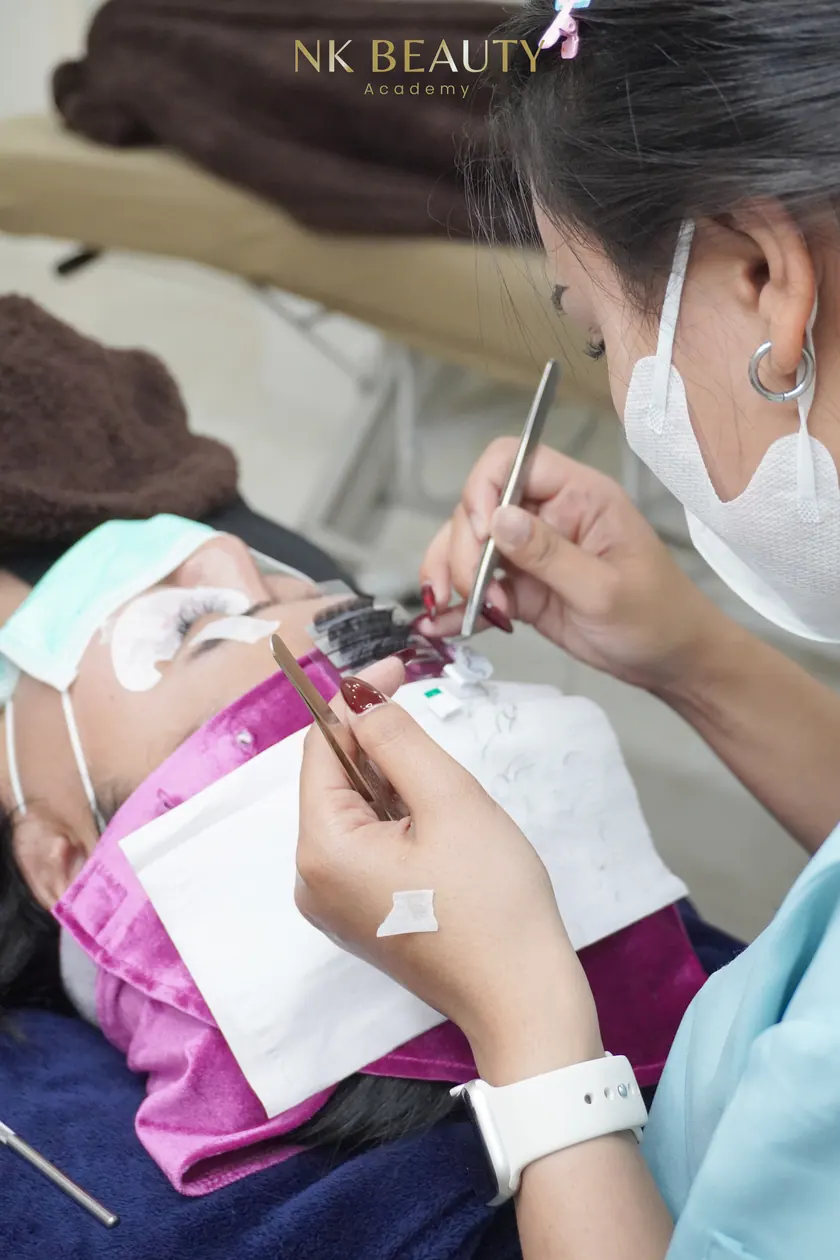 Lash extensions being applied, photographed during training at NK Beauty Academy