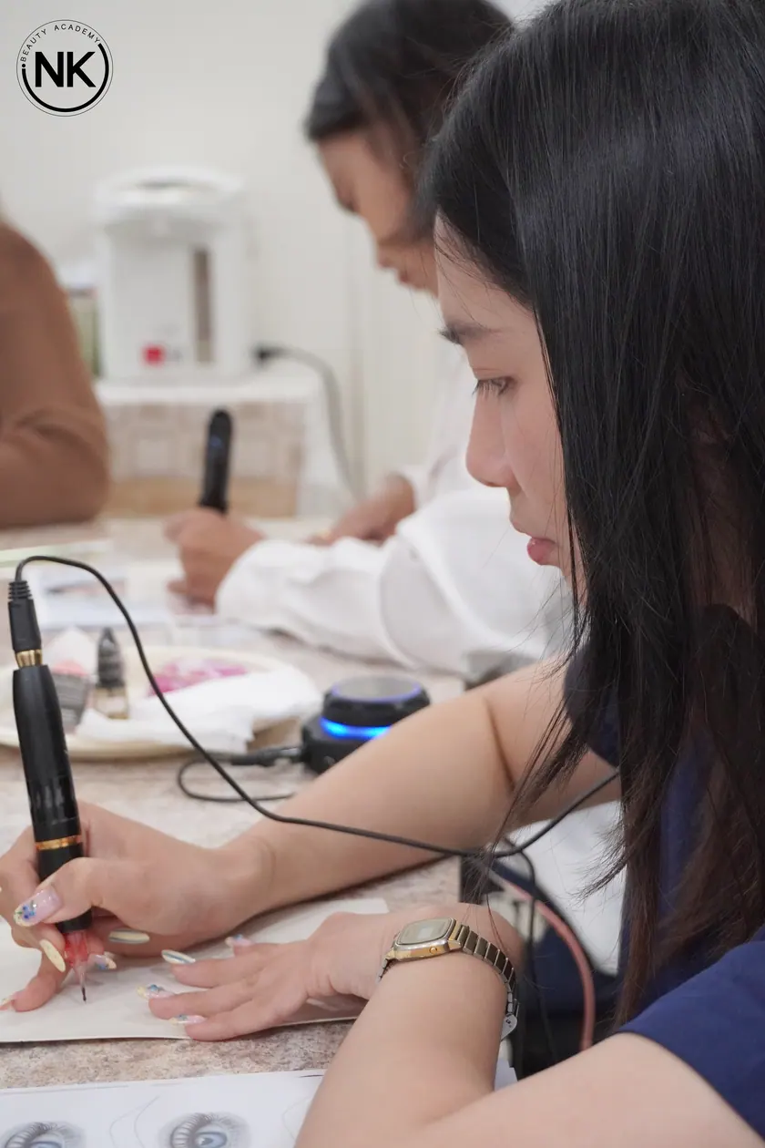 A student working on a live model during the hands-on part of the course