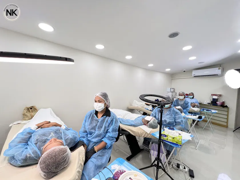 The group gathered around a live model while a technique is demonstrated