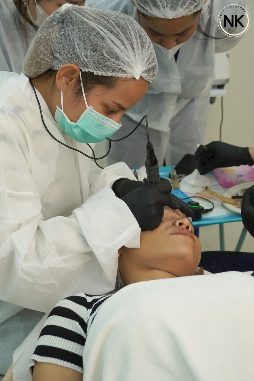 A student working on a live model during the hands-on part of the course