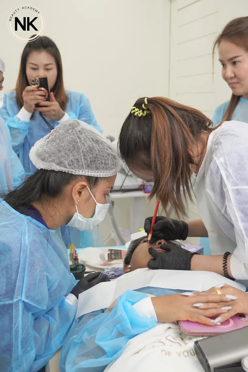 A student working on a live model during the hands-on part of the course