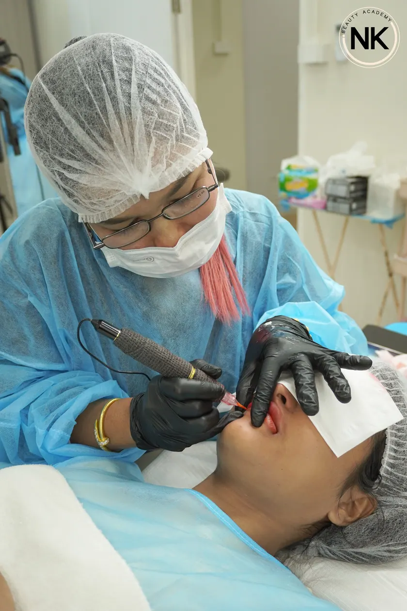 A student working on a live model during the hands-on part of the course