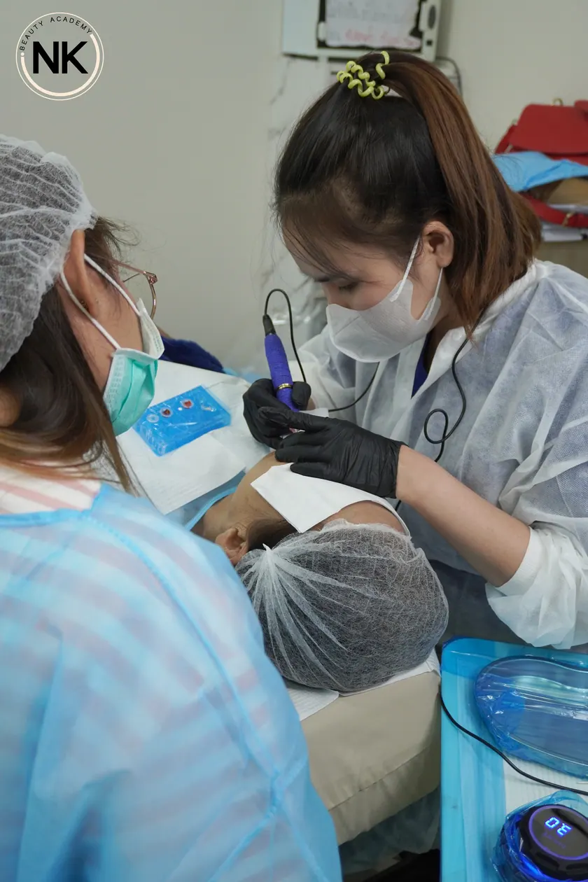 A student working on a live model during the hands-on part of the course