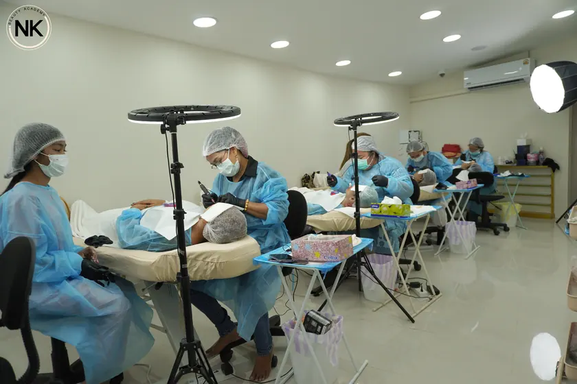 A student practising with tweezers and a lash tray during the course