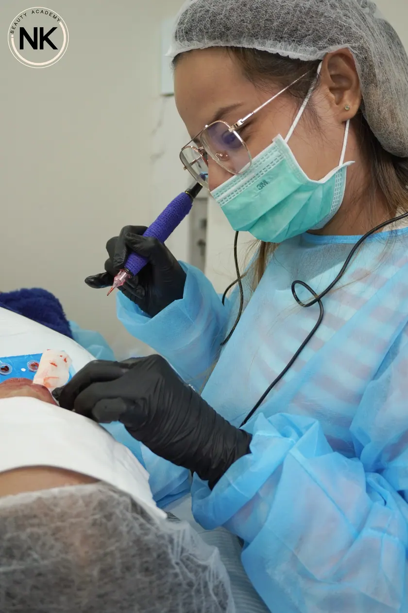 A student working on a live model during the hands-on part of the course