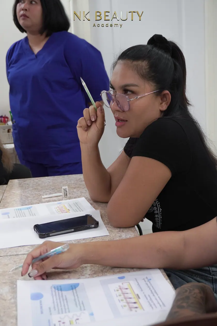 A student practising with tweezers and a lash tray during the course