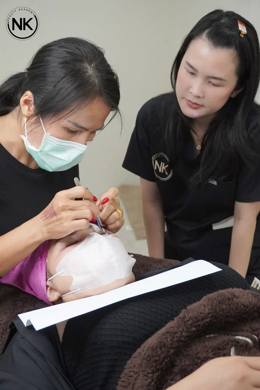 Lash extensions being applied, photographed during training at NK Beauty Academy