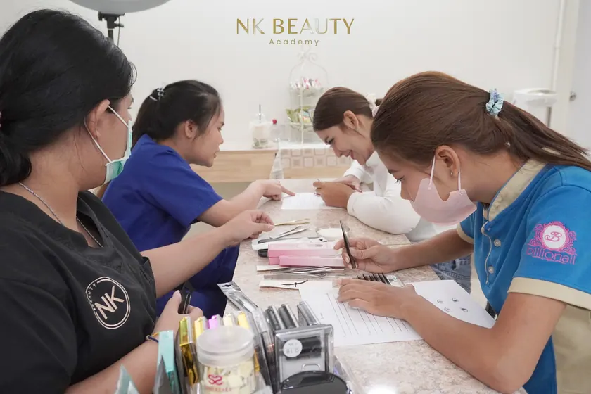 A student practising lash work at the training bench before working on a model