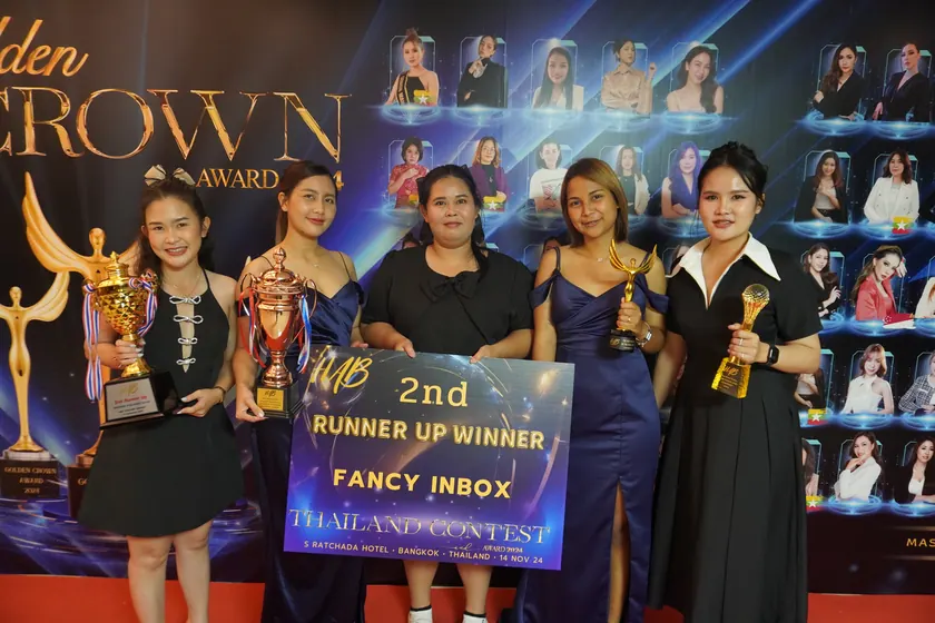The NK Beauty team on stage at the Golden Crown Award ceremony, holding trophies