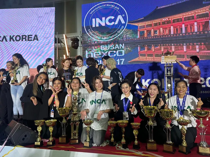The team with a display of trophies at the INCA event in Korea