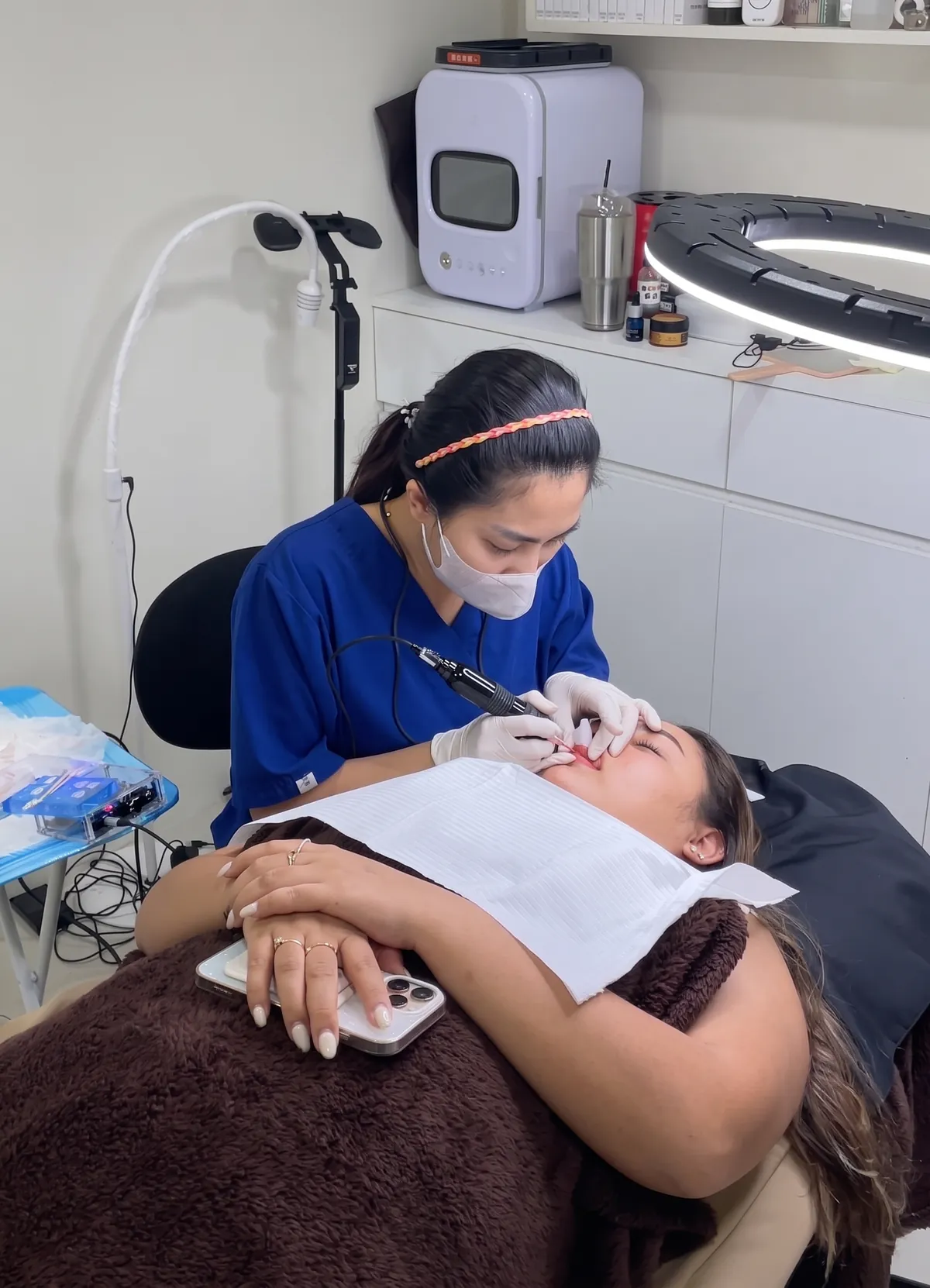 An artist working on a permanent makeup appointment at Kathu