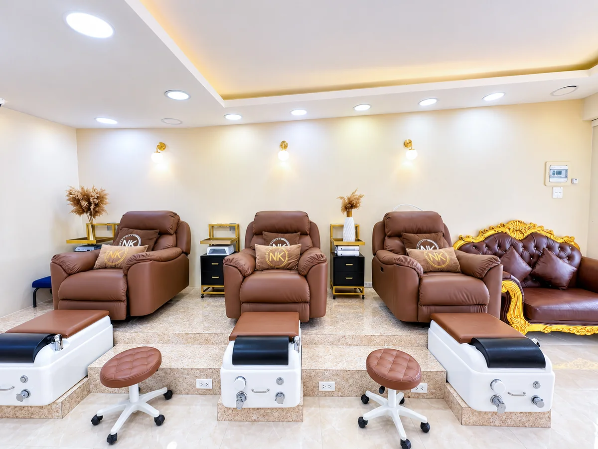 Three pedicure recliners and a gilded sofa at NK Beauty Kathu