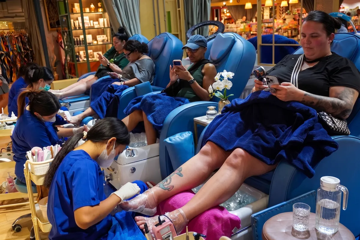 Clients having pedicures in the blue recliners at NK Beauty Patong