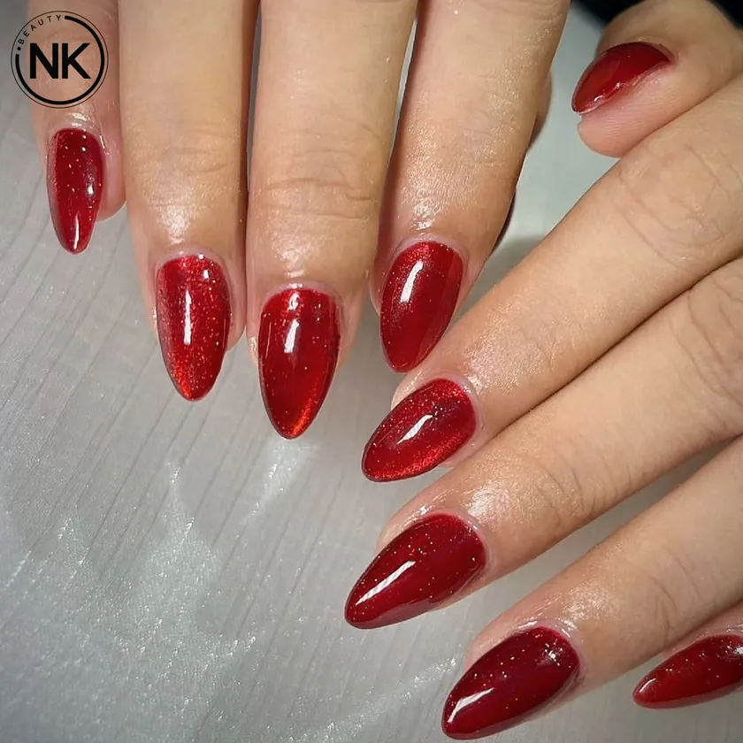 Nail work at NK Beauty: Glossy red almond nails
