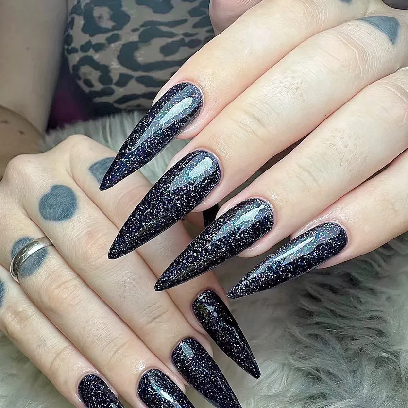 Nail work at NK Beauty: Black glitter stiletto nails