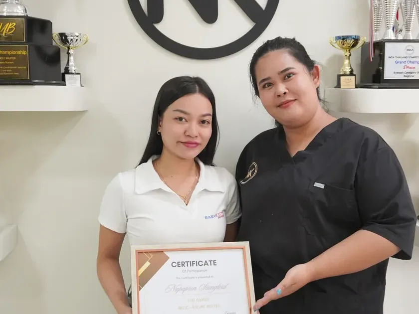 An NK Beauty Academy graduate with a course certificate