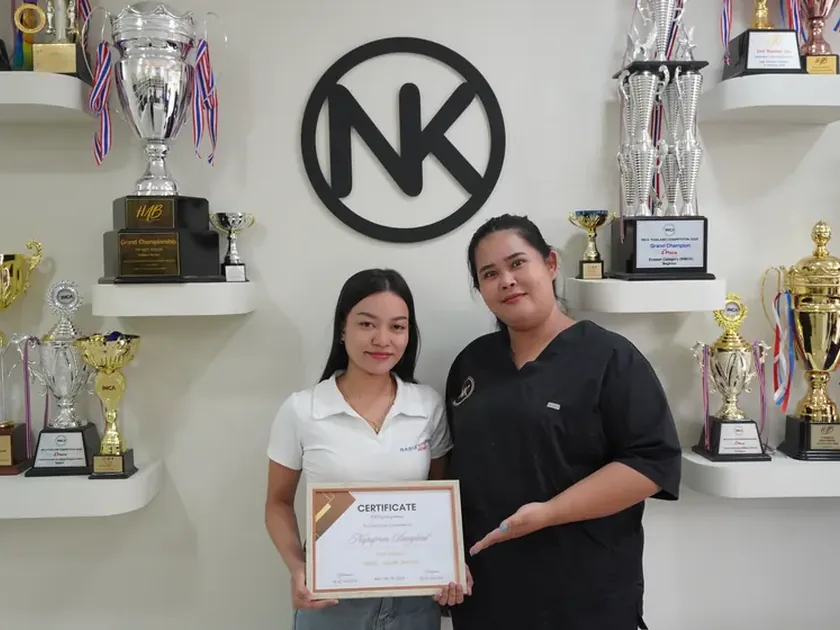 An NK Beauty Academy graduate with a course certificate