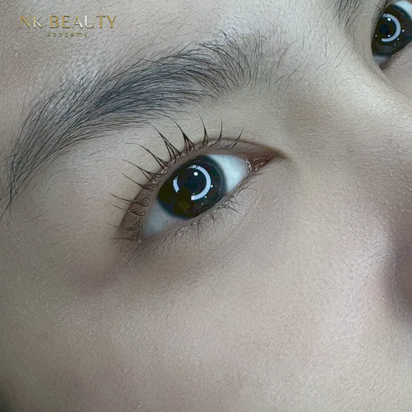 Student work: a healed permanent brow with lash extensions, seen in profile