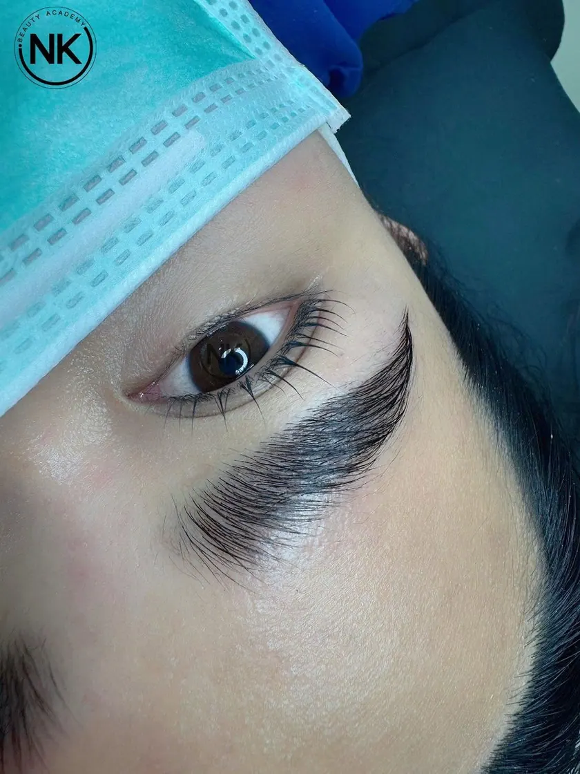 Student work: a defined brow and lash line on a client wearing a face mask
